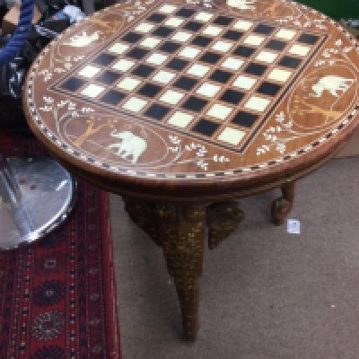 A inlaid occasional table with game board inset in mother of pearl.