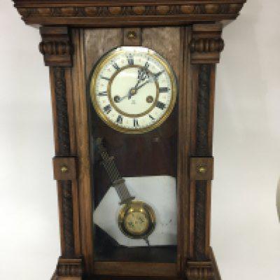 Two Vienna Type walnut cased wall clocks with enamel dials key and pendulum.