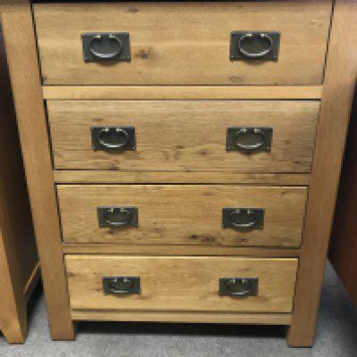 A pine chest of drawers the the rectangle top above four drawers .