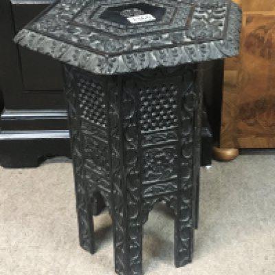 A Middle Eastern type carved hardwood occasional table the hexagonal top on a folding stand Hight 45cm