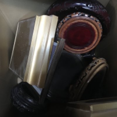 A box containing a collection of carved hardwood oriental stands.