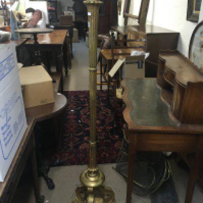 A gilt wood standard lamp with a fluted column and scroll base.
