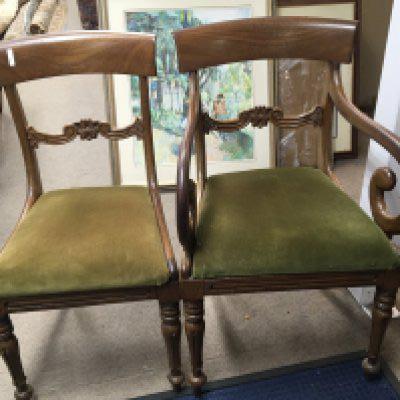 An Early Victorian mahogany drop leaf dinning table and a set of eight mahogany dining chairs with drop in seats including a pair of open are chairs with scrolls.