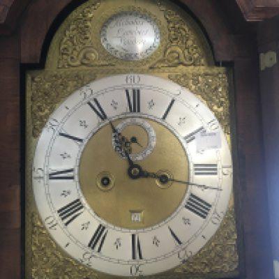 A Quality 18th century walnut long case clock the case with fine kingwood and satinwood floral inlay the hood with raised finials maker Nicholas Lambert London with arched brass dial silvered chapter ring date aperture. the movement eight day going striking on a bell with weights and pendulum.