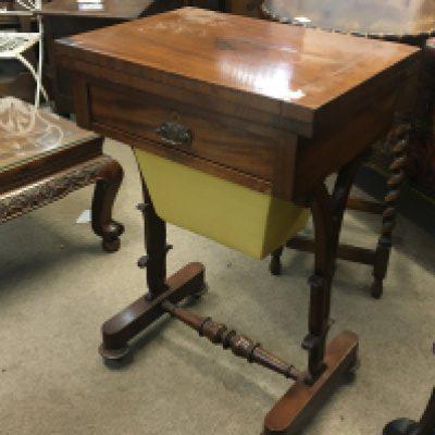 A Victorian mahogany work box games table the hinged top with a green above a single drawer on shaped supports.