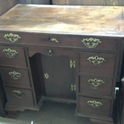 A George III 18th century red walnut Knee hole writing desk The rectangular top above flights of drawers and one long drawer on ogee bracket feet oak lined drawers. Width 79cm under 3ft.