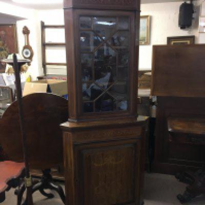 An Edwardian inlaid mahogany corner cabinet with a single glazed door above satinwood inlaid cupboard door.