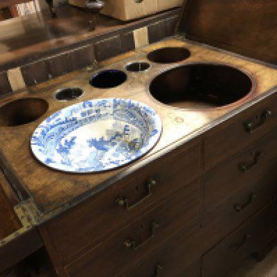 A Quality George III mahogany campaign type dressing chest. The sides with brass carrying handles the hinged top section with retractable mirror and fitted wash bowl compartment. above drawers with well fitted interior.on bracket feet. 76cm wide 88cm high