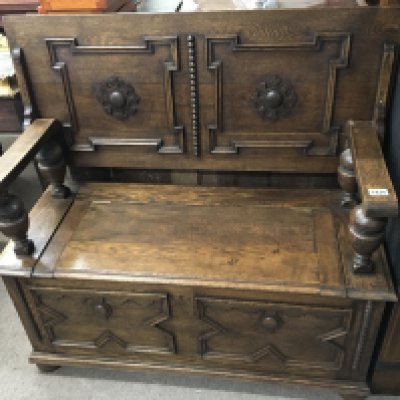 An Oak Hall seat with a hinged back and seat above applied moulding ornamentation. length 107cm