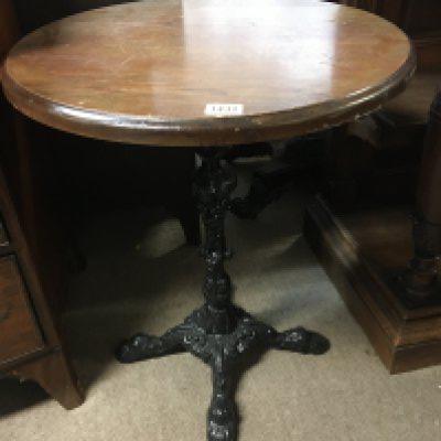 A pub type table with a circular wooden top on a wrought iron base. Top diameter 60cm wideNo Reserve