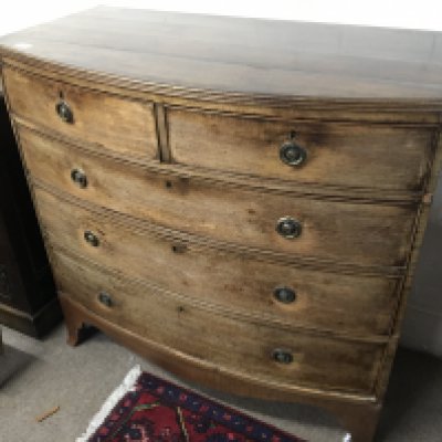 A late George III mahogany bow fronted chest of drawers fitted with two short and three long drawers on swept bracket feet length 109cm