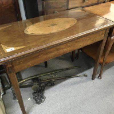 An Edwardian inlaid mahogany card table the rectangular top with a satinwood fan shaped oval medallion