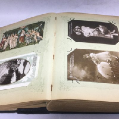 An album containing over 150 postcards on various subjects including Easter, Christmas etc.