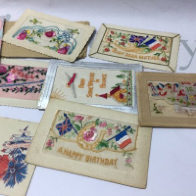 A small collection of French silk postcards.