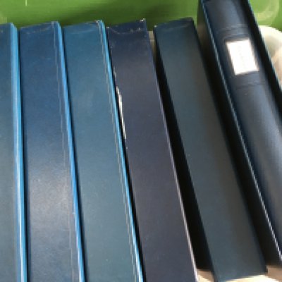 A box containing six albums of jersey stamps .