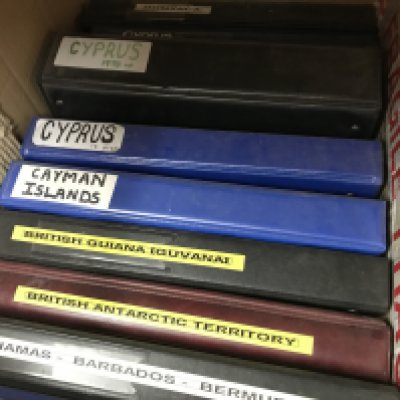 A box containing nine albums of world stamps