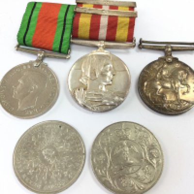 A collection of WW1 & 2 medals including a WW1 war medal presented to a PTE. P. Cartier. IR.GDS, Volunteer Medical Service Dress Miniature Medal with three clasps presented to a Mrs. Phyllis A. Webber. Also Including Two commemorative coins Postage category A