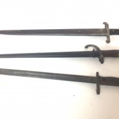 Three I world war or earlier bayonets an American military bayonet stamped US and date 1917 A French 1874 pattern bayonet and a German bayonet possible S98 pattern (3)