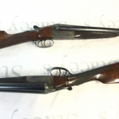 A pair of quality numbered 1 & 2 side by side shotguns attributed to churchill guns for Harrods Ltd in a fitted leather case. Walnut stock with chequered grip and twin triggers. 63cm barrels and 105cm overall length. PLEASE NOTE THAT A SHOGUN LICENSE IS REQUIRED TO PURCHASE THIS LOT. VIEWING AND COLLECTION IS BY APPOINTMENT ONLY.