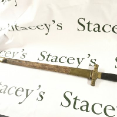 An unusual short sword with a gilt lions head pommel, leather and gilt scabbard. Scabbard is stuck to the blade . 75cm total length