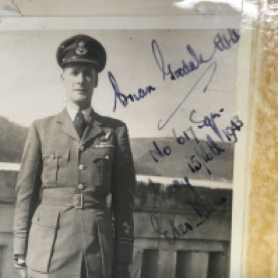 A signed photo of Brian Goodale and a copy of the Dam busters book. Postage B