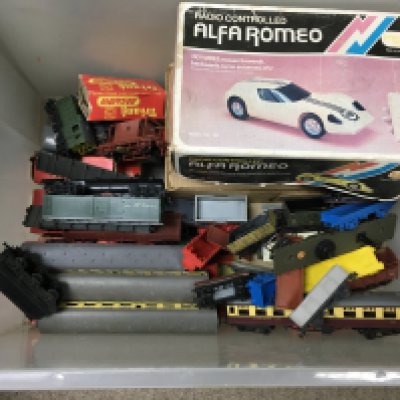 A box filled with a train set and other vintage toys. NO RESERVE
