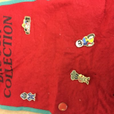 Four golly badges on the collectors cloth .