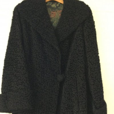 A vintage Astrakhan coat with oriental inner lining l