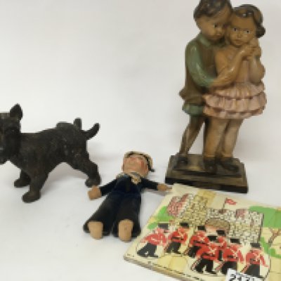 A Vintage Camberwick green puzzle a plaster Saucy figure a vintage sailor doll and a cast metal figure of a dog. (4)