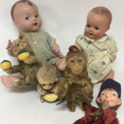 A collection of Vintage toys two composition dolls and a clockwork monkey band.