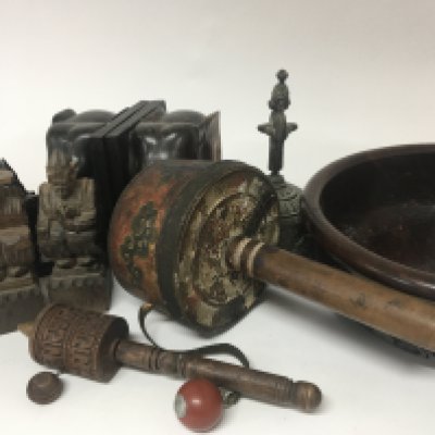 Two old Tibetan prayer wheels a carved treen bowl elephant bookends a Tibetan hand bell and other oddments.