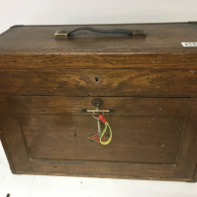 A Neslein oak woodworking precision tool chest with a hinged top the front panel revealing a flight of drawers.
