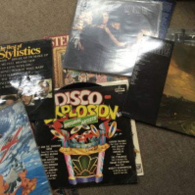 A box of various music albums including Fleetwood Mac and pink Floyd .