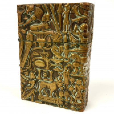 An antique C.1930s pressed brass cased lighter decorated with Egyptian symbols. 6cm. (A) NO RESERVE