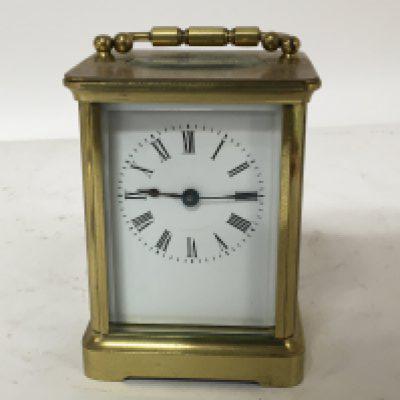 A brass cased carriage clock enamel dial seen working. Height 11cm