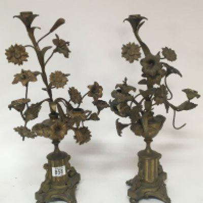 A pair of gilt metal table candelabra of French Rococo style. With raised flowers the sides with winged cherubs. Height 48cm