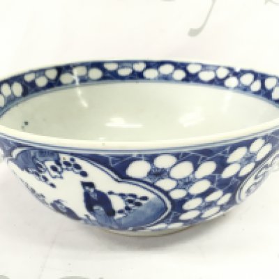A 19th century Chinese blue and white bowl decorated with figures and cherry blossom. Four character mark at the base, 20.5cm wide. Small chips seen .This lot cannot be posted