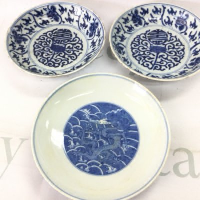 Three Chinese blue and white dishes . Hairline cracks and chips seen on one of the dishes.