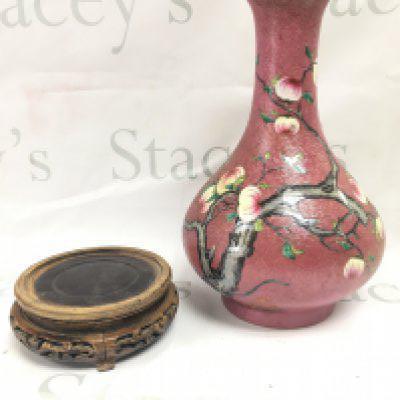 A Chinese Famille rose vase , 29cm tall. Wooden stand has a leg missing . This lot cannot be posted