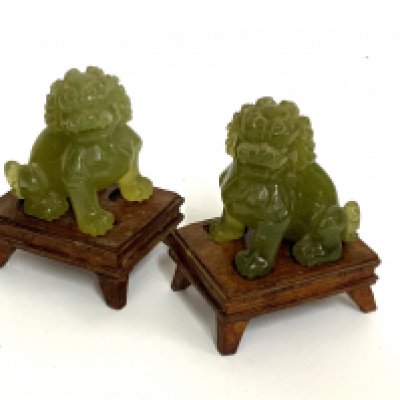 A small pair of carved jade lion dogs mounted pin carved wooden bases. (B)