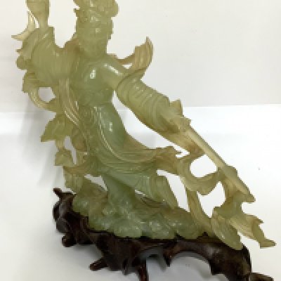 A 20thC carved Jade figure of a Chinese warrior princess holding a pearl and sword. (D)