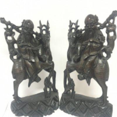 A pair of quality Chinese late 19th century carved hardwood figures in the form of elders seated on deer with hanging monkeys and delicately decorated with fine silver inlay Hight 46cm. Slight damage see illustrations.