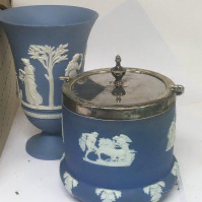 A Wedgwood blue Jasperware biscuit barrel and vase and a box containing silver plate and brassware.