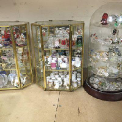 Four small display cabinets containing thimbles and crystals ornaments.