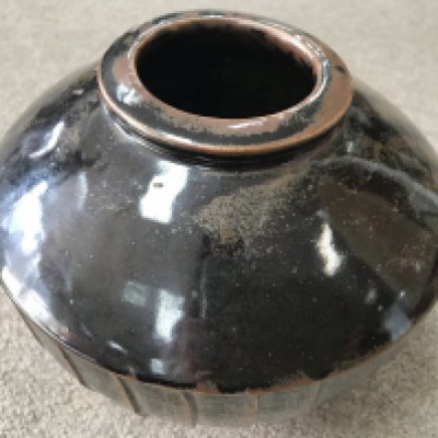 A David Leach stoneware vase with brown glaze and incised decoration. 18cm