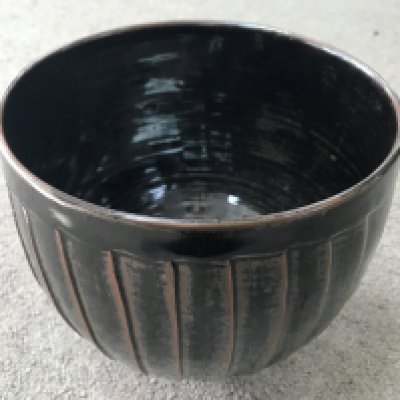 A David Leach stoneware bowl with brown glaze and incised decoration. 18cm