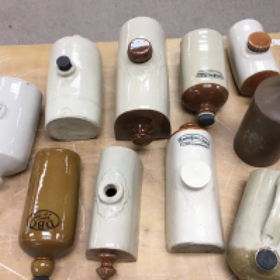 A collection of stoneware bed warmers. Postage D