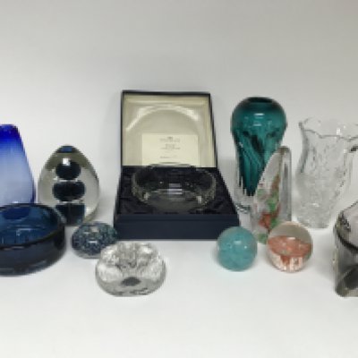 A mixed collection of glassware including paperweights bowls and vases as well as a limited edition Caithness mayflower piece and a Wedgwood elephant paperweight.