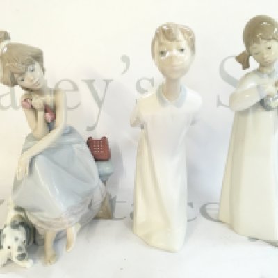 Three Lladro figures , 21cm tall. This lot cannot be posted