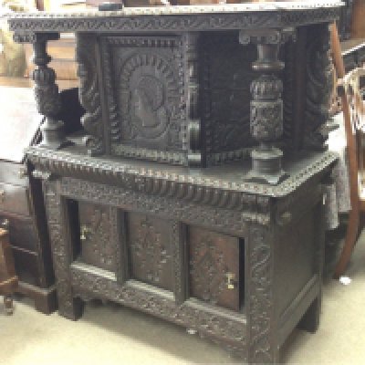 Withdrawn -A 17th Century carved oak Court Cupboard the top section with carved pillars and a single cupboard above sliding doors. An interesting Court Cupboard with later alterations.116cm wide height 134cm